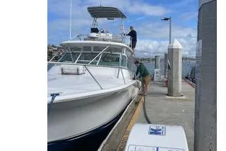 Slide: The Image of 2004 Luhrs 38 Open boat docked at marina with people onboard. - 16