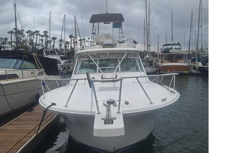 Slide: The Image of 2004 Luhrs 38 Open boat docked in a marina with overcast skies. - 3