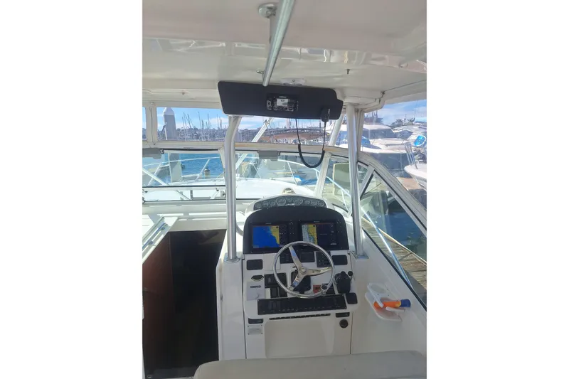 Slide: The Image of Interior view of a 2004 Luhrs 38 Open yacht helm station. - 30
