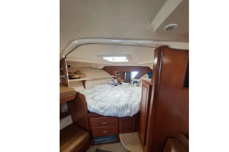 Slide: The Image of Interior of 2004 Luhrs 38 Open with cozy bed and wood paneling. - 32