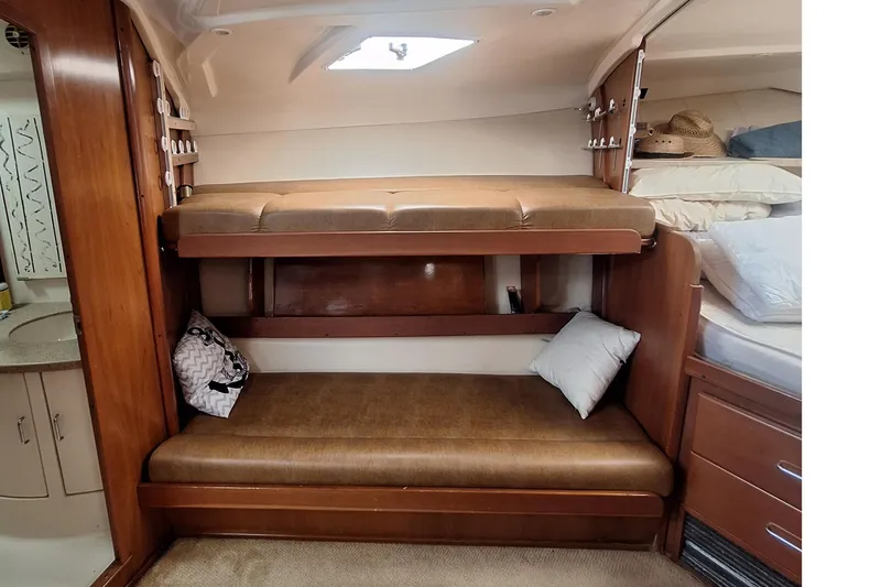 Slide: The Image of Interior of 2004 Luhrs 38 Open with bunk beds and wood paneling. - 35