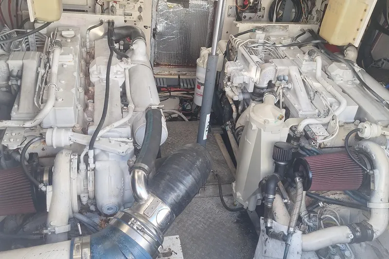 Slide: The Image of Engine room of a 2004 Luhrs 38 Open boat, showcasing dual engines and mechanical components. - 37