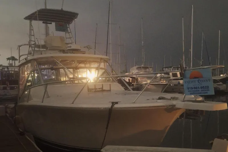 Slide: The Image of 2004 Luhrs 38 Open yacht docked at night, illuminated by marina lights. - 4