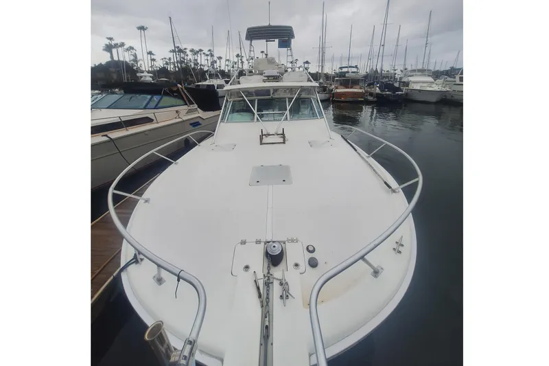 Slide: The Image of 2004 Luhrs 38 Open boat docked in a marina under cloudy skies. - 5