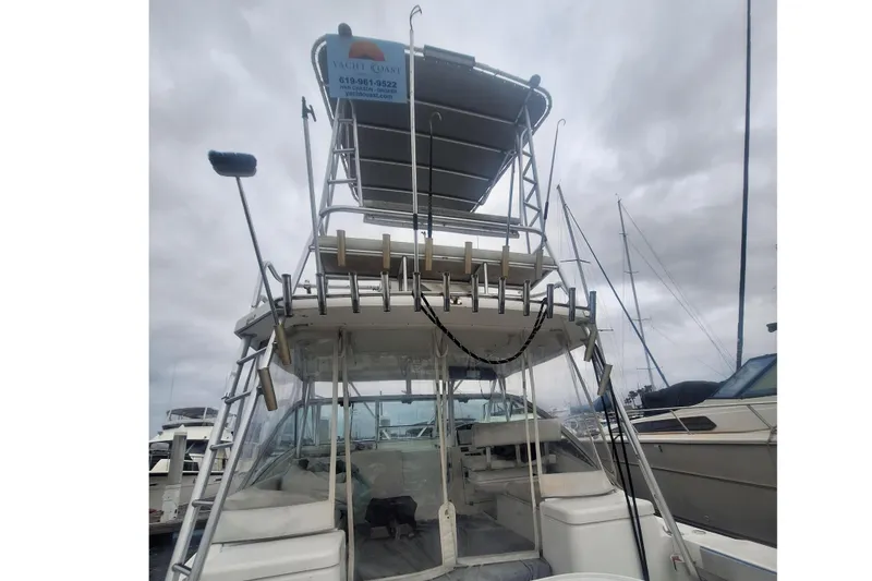Slide: The Image of 2004 Luhrs 38 Open boat with tower, docked under cloudy skies. - 6