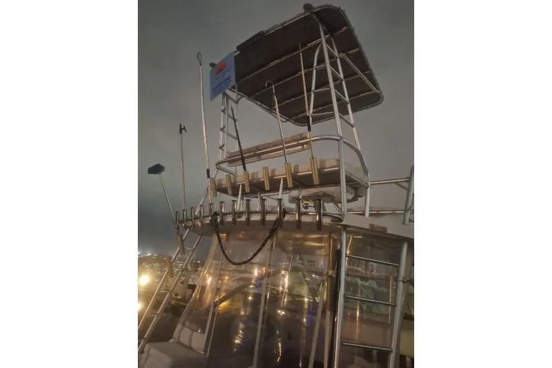 Slide: The Image of 2004 Luhrs 38 Open boat with elevated helm station at night. - 7
