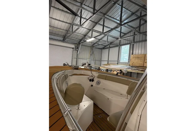 Slide: The Image of 2016 Key West 244 Center Console boat in a metal storage shed. - 13
