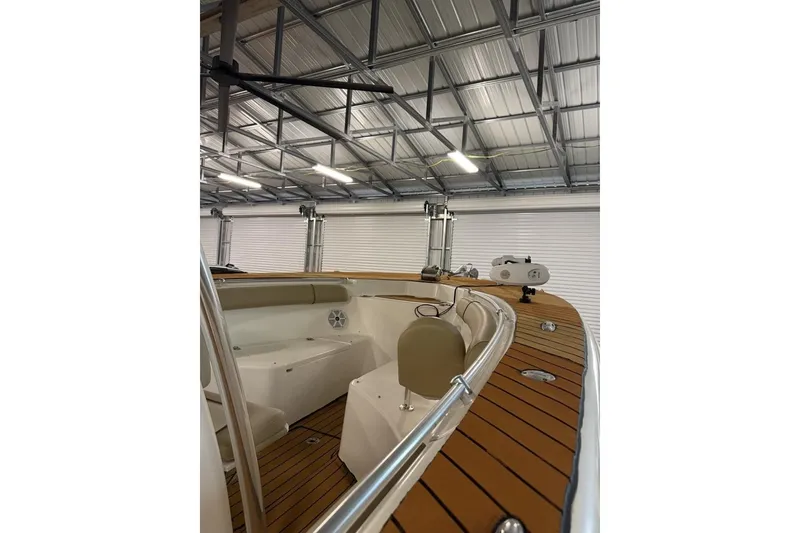 Slide: The Image of 2016 Key West 244 Center Console boat interior with wood accents in a garage. - 14