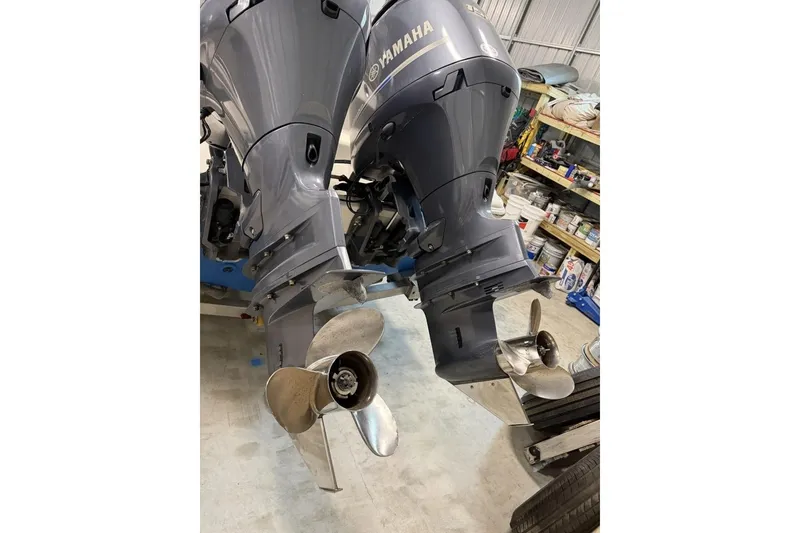 Slide: The Image of Twin Yamaha outboard motors on a 2016 Key West 244 Center Console boat in a workshop. - 17