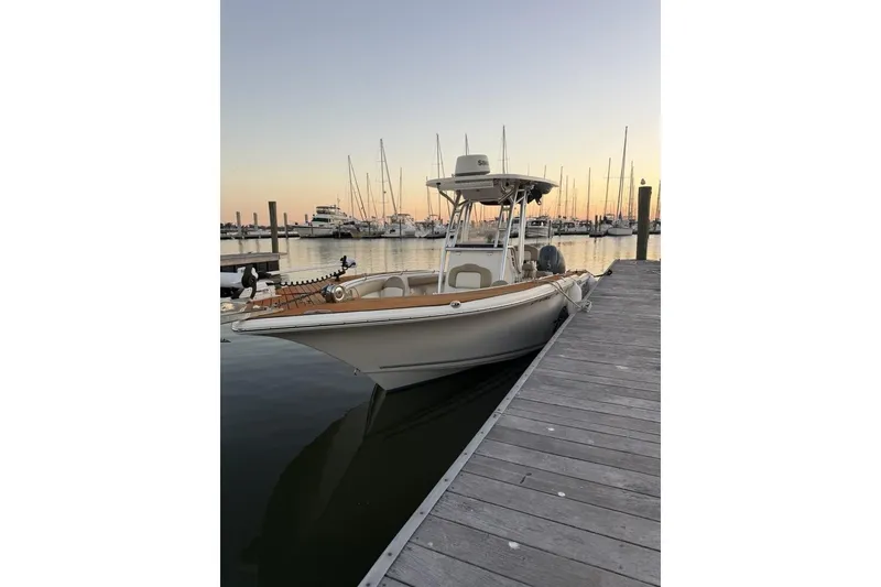 Slide: The Image of 2016 Key West 244 Center Console boat docked at sunset in a marina. - 19