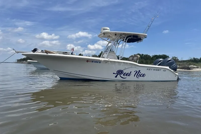 Slide: The Image of 2016 Key West 244 Center Console boat named "Reel Nice" on calm water. - 20
