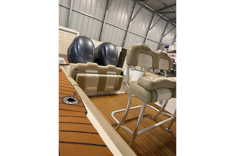 Slide: The Image of 2016 Key West 244 Center Console boat interior with dual engines and cushioned seating. - 15