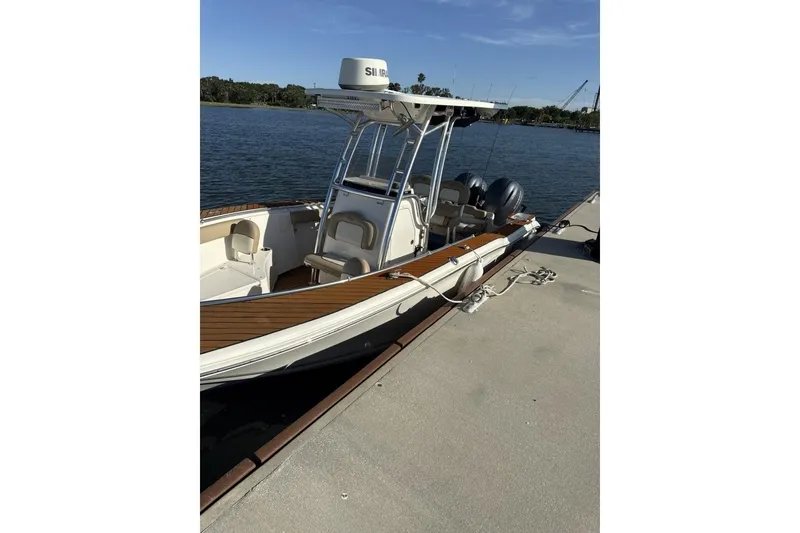 Slide: The Image of 2016 Key West 244 Center Console boat docked by the water. - 18