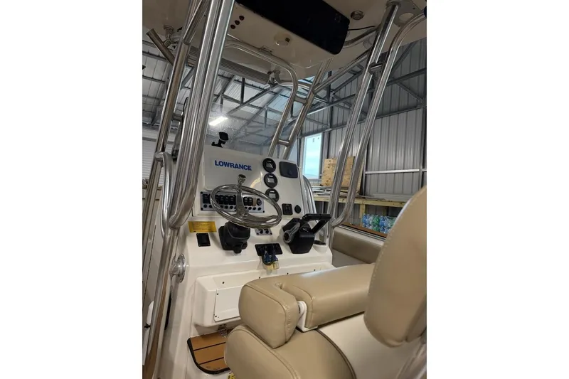 Slide: The Image of 2016 Key West 244 Center Console boat interior with steering wheel and controls. - 7