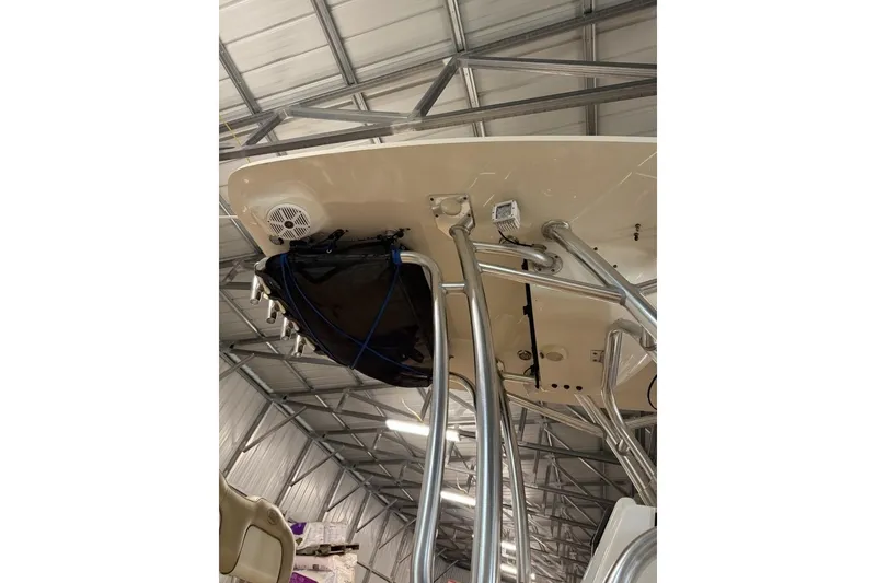 Slide: The Image of 2016 Key West 244 Center Console boat underside view in a metal-roofed storage facility. - 8
