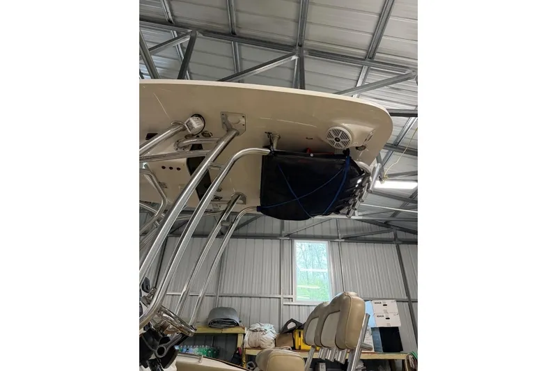 Slide: The Image of 2016 Key West 244 Center Console boat stored in a metal garage. - 9