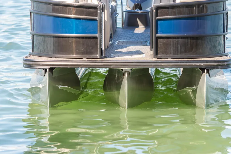 The Image of 2024 Barletta L23U pontoon boat on calm green water, rear view. - 1