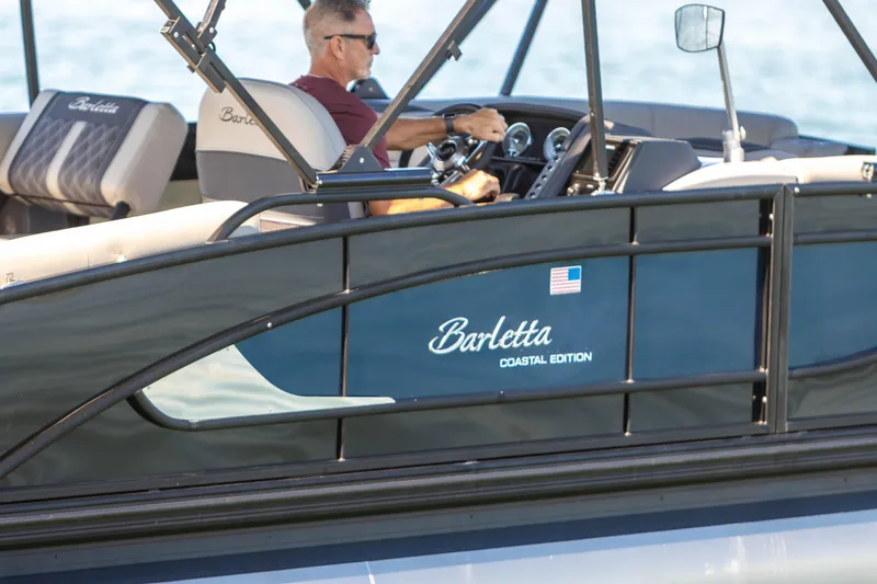 Slide: The Image of 2024 Barletta L23U Coastal Edition pontoon boat on water, featuring sleek design and comfortable seating. - 19