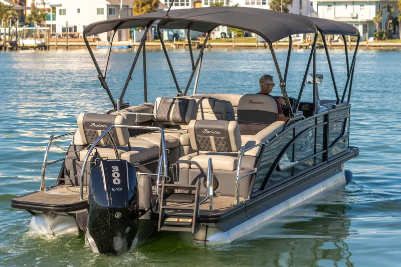 Slide: The Image of 2024 Barletta L23U pontoon boat cruising on a sunny day with a powerful Mercury 300 V8 engine. - 21