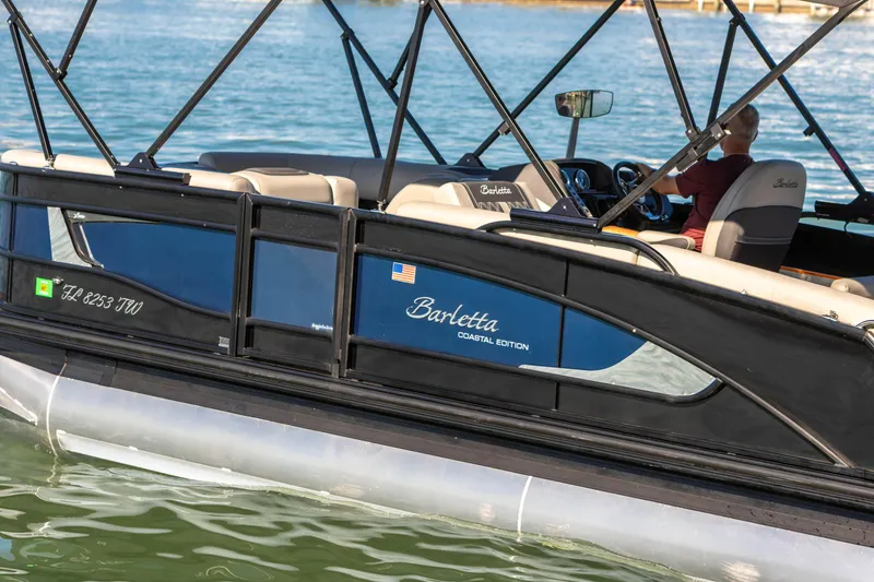Slide: The Image of 2024 Barletta L23U pontoon boat on water, featuring coastal edition design. - 25