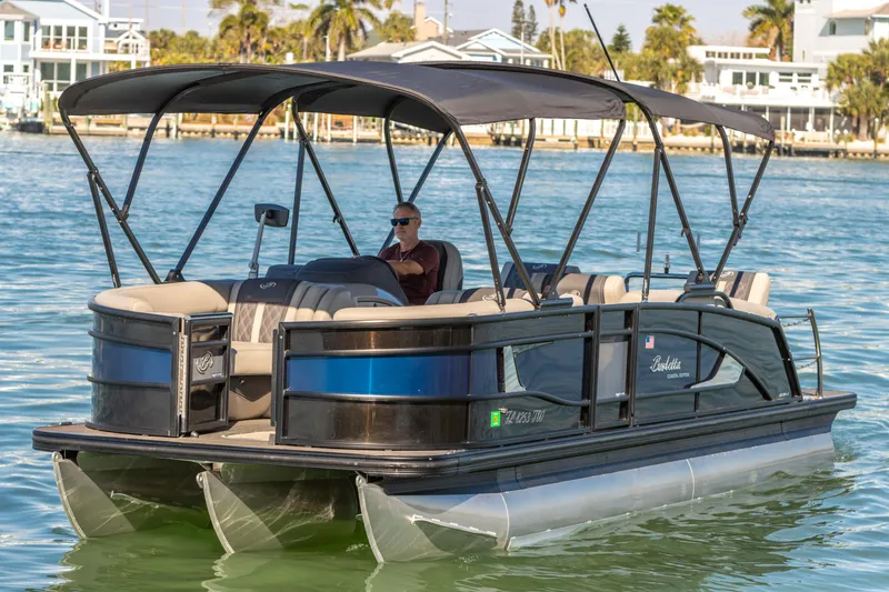 Slide: The Image of 2024 Barletta L23U pontoon boat cruising on a sunny day. - 27