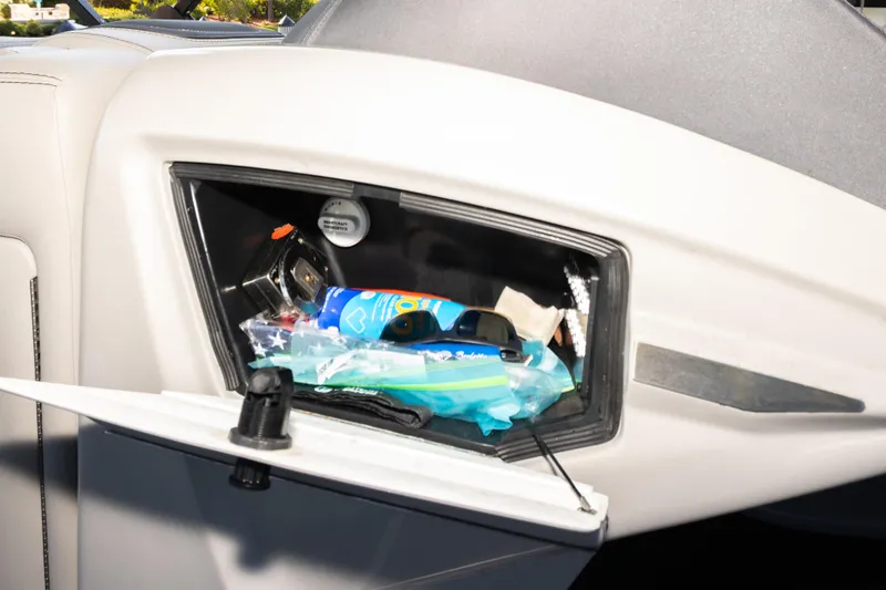 Slide: The Image of Storage compartment in a 2024 Barletta L23U boat, containing various items. - 35
