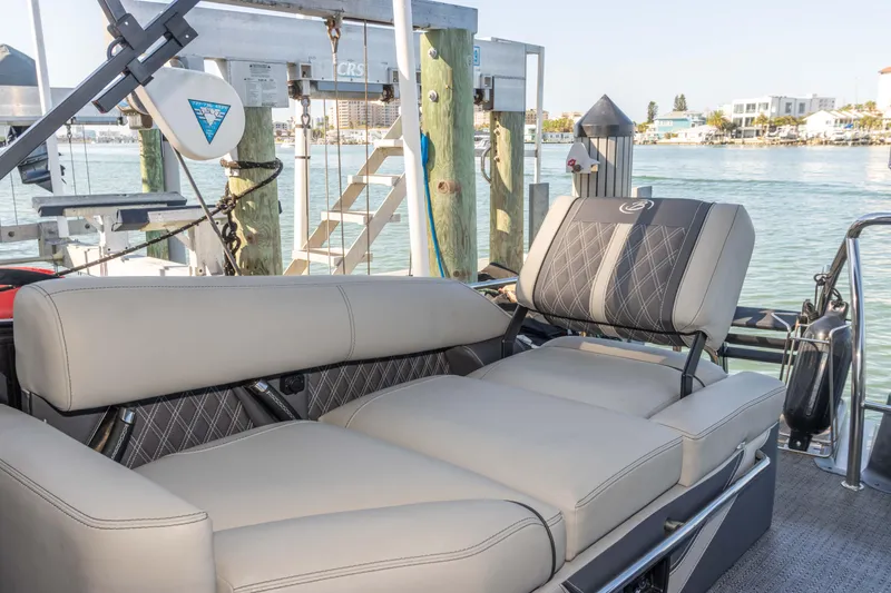 Slide: The Image of 2024 Barletta L23U boat interior with luxurious seating by the water. - 36