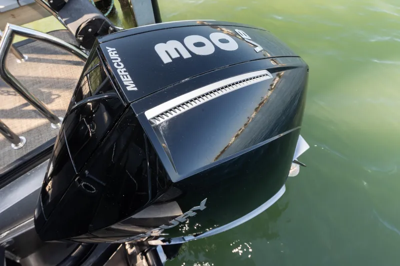 Slide: The Image of 2024 Barletta L23U boat with Mercury outboard engine on water. - 37