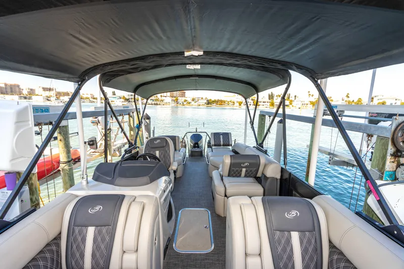 Slide: The Image of 2024 Barletta L23U pontoon boat interior with luxurious seating and waterfront view. - 40