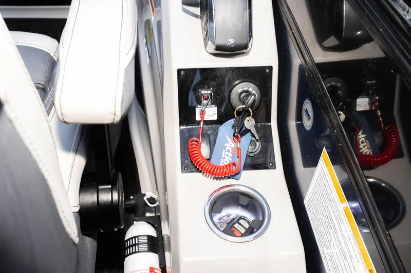 Slide: The Image of 2024 Barletta L23U boat console with ignition keys and safety features. - 45