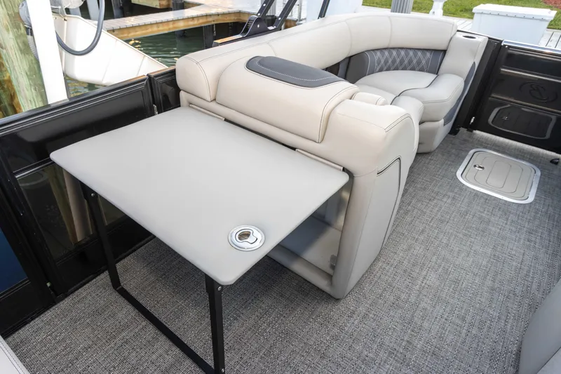 Slide: The Image of 2024 Barletta L23U boat interior with plush seating and foldable table. - 48