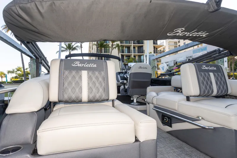 Slide: The Image of 2024 Barletta L23U pontoon boat interior with luxurious seating and elegant design. - 56