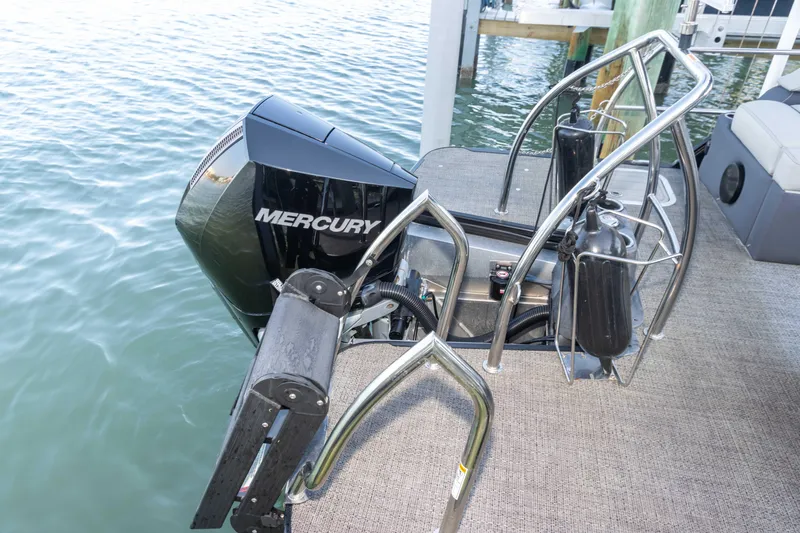 Slide: The Image of 2024 Barletta L23U boat with Mercury outboard motor on water. - 59