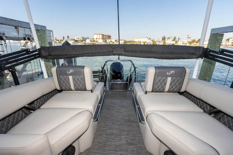 Slide: The Image of 2024 Barletta L23U pontoon boat interior with luxurious seating and waterfront view. - 61