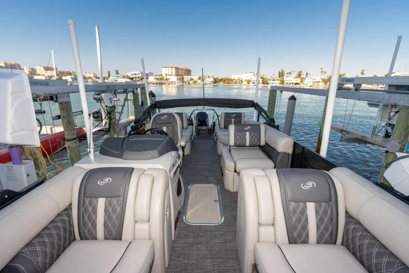 Slide: The Image of 2024 Barletta L23U pontoon boat interior with luxurious seating and waterfront view. - 62