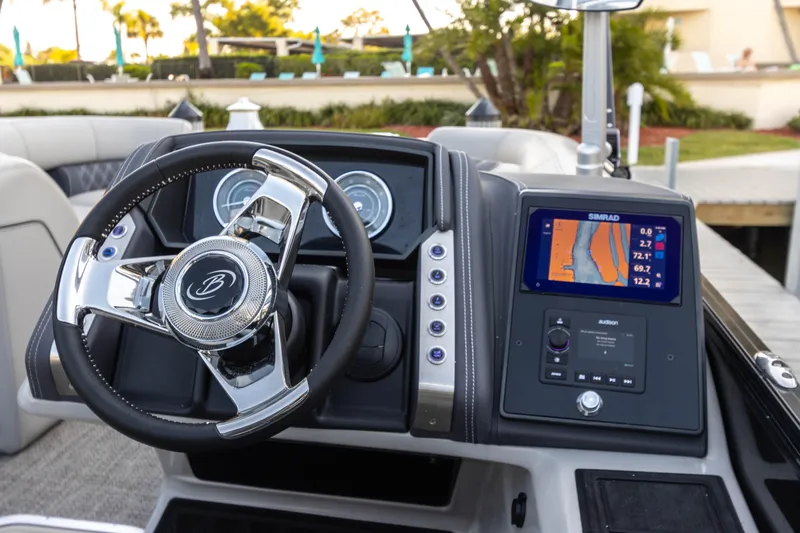 Slide: The Image of 2024 Barletta L23U boat dashboard with steering wheel and navigation display. - 65