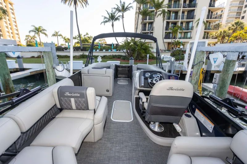 Slide: The Image of 2024 Barletta L23U pontoon boat interior with luxurious seating and modern dashboard. - 67