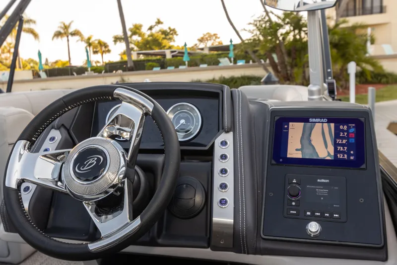 Slide: The Image of 2024 Barletta L23U boat dashboard with steering wheel and navigation display. - 68