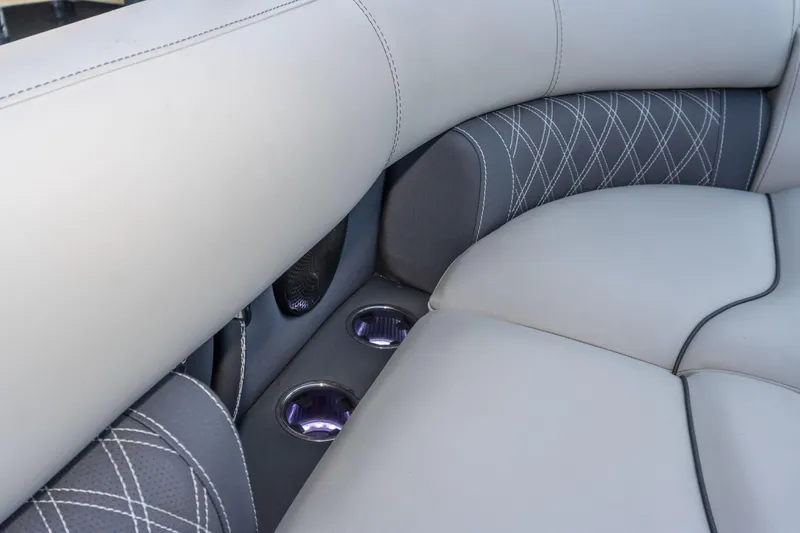 Slide: The Image of 2024 Barletta L23U boat interior with luxurious seating and cup holders. - 69