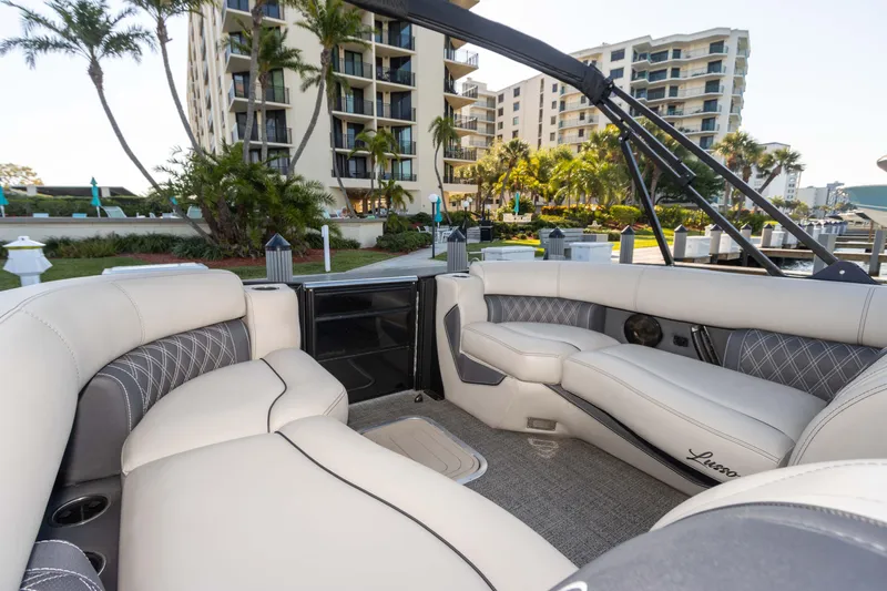 Slide: The Image of Luxurious interior of 2024 Barletta L23U boat docked near waterfront apartments. - 70