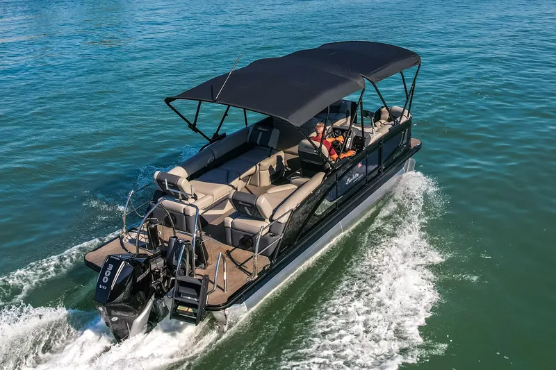 Slide: The Image of 2024 Barletta L23U pontoon boat cruising on clear blue water. - 72