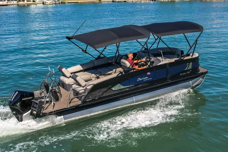 Slide: The Image of 2024 Barletta L23U pontoon boat cruising on clear blue water. - 73