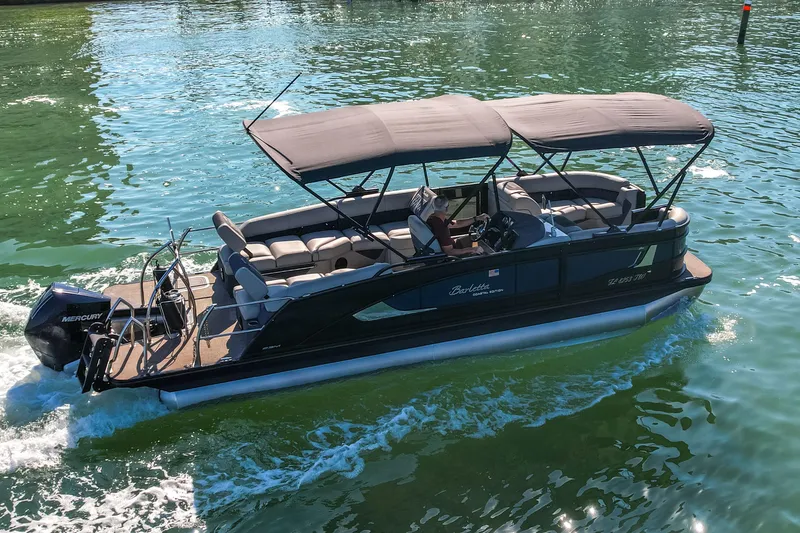 Slide: The Image of 2024 Barletta L23U pontoon boat cruising on clear water. - 75