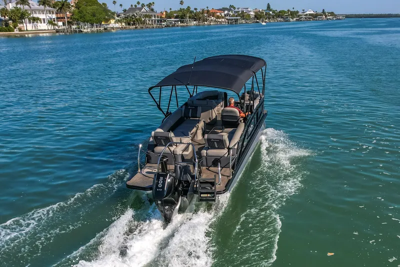 Slide: The Image of 2024 Barletta L23U pontoon boat cruising on a scenic waterway. - 81