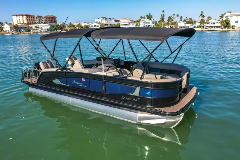Slide: The Image of 2024 Barletta L23U pontoon boat on calm water, featuring sleek design and spacious seating. - 82