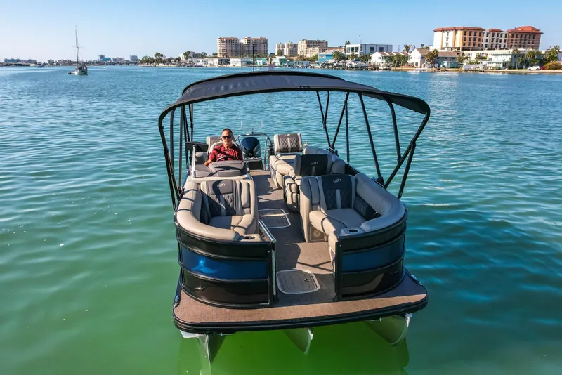 Slide: The Image of 2024 Barletta L23U pontoon boat on calm water, featuring spacious seating and canopy. - 83