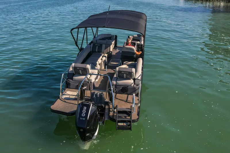 Slide: The Image of 2024 Barletta L23U pontoon boat cruising on calm water, featuring spacious seating and a powerful engine. - 87