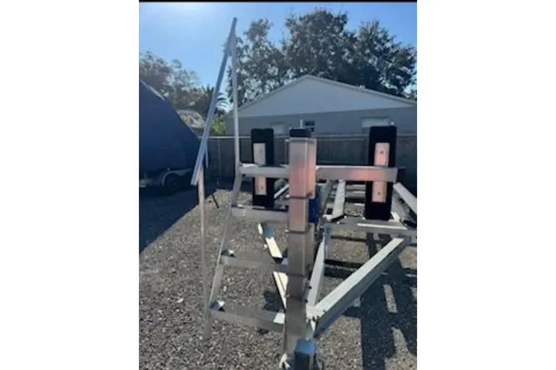 Slide: The Image of 2024 Barletta L23U boat trailer in a sunny outdoor setting. - 94