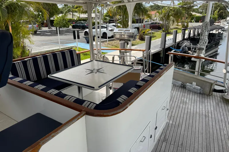 Slide: The Image of Outdoor seating area on 1982 Custom Virpack Steel Hull boat docked by a canal. - 10