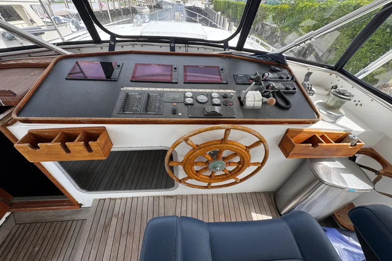Slide: The Image of Cockpit of 1982 Custom Virpack Steel Hull boat with wooden steering wheel and navigation controls. - 11